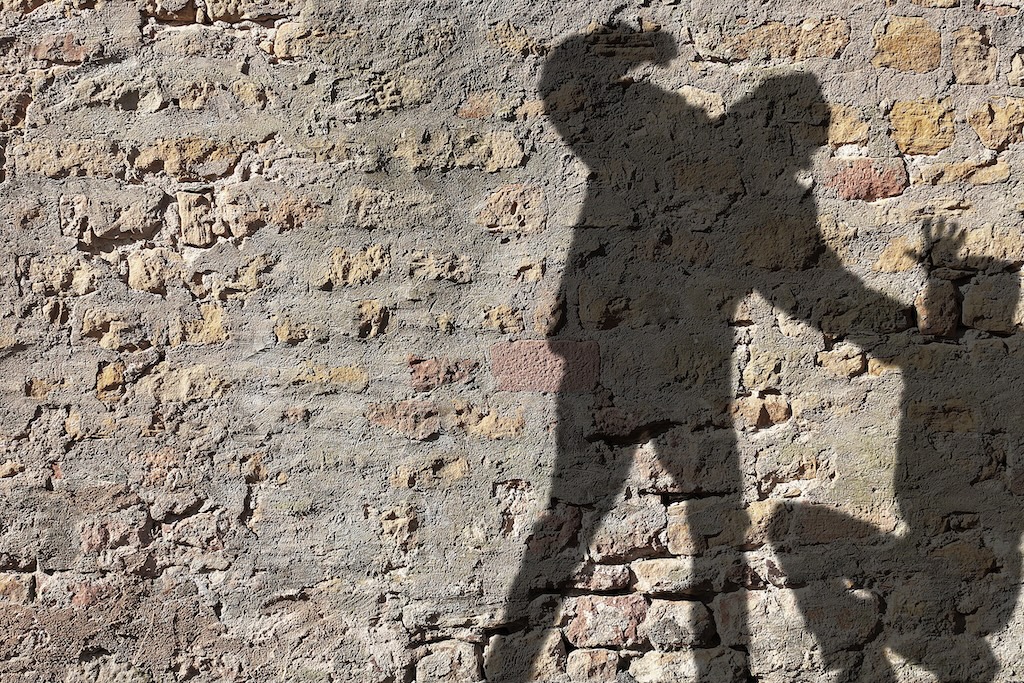 Shadow of 2 figures, one assaulting someone else crouching down. | Richard P. Davies, Esq. Shadow of 2 figures, one assaulting someone else crouching down.
