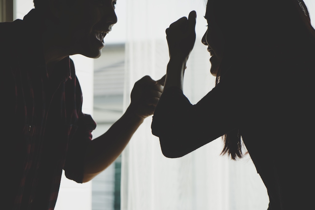 Silhouette couple is fighting by the windows Silhouette couple is fighting by the windows